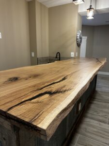 Live edge white oak counter closeup detail. Resin filled.