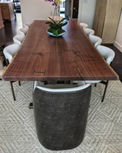 Book matched live edge walnut dining table with steel inlays