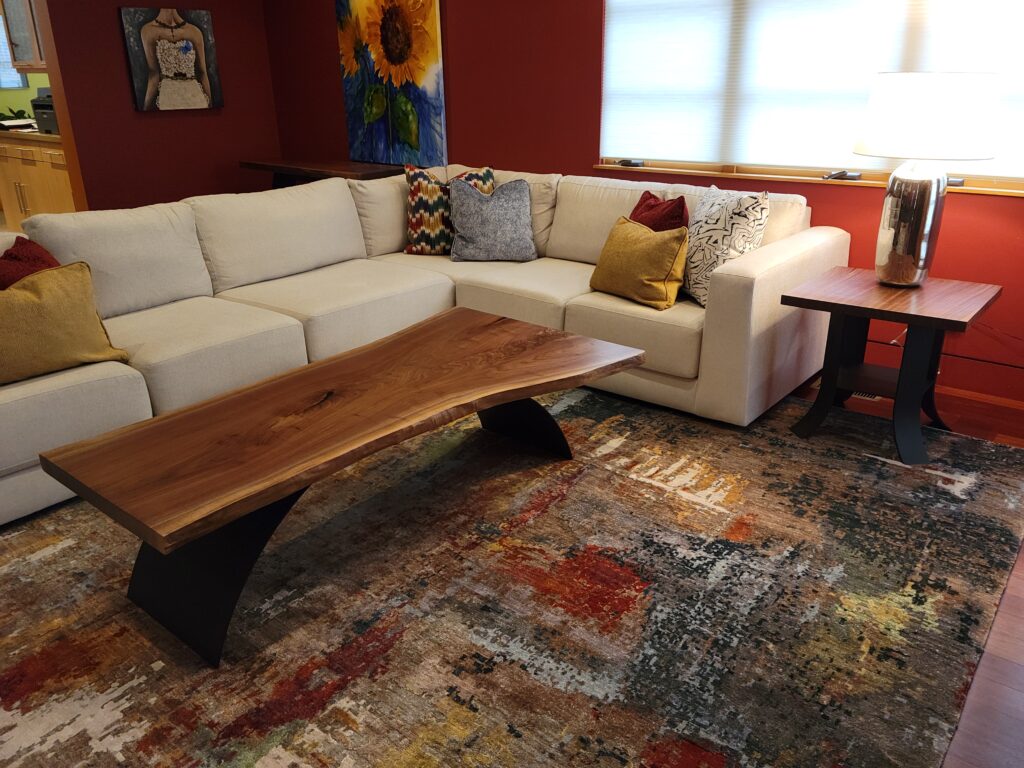 Walnut slab coffee table with rolled steel base